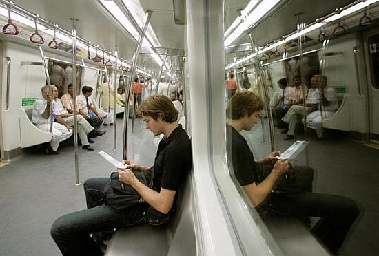 Passengers sit inside a Delhi Metro Rail compartment.