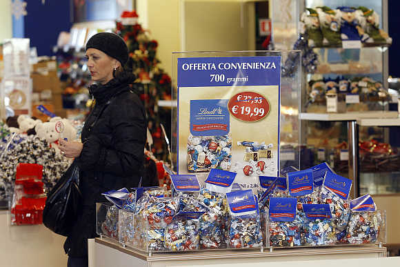 A woman browses a chocolate shop in Rome, Italy.