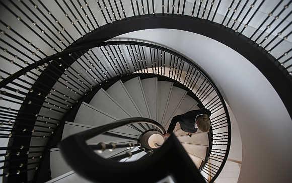 A woman walks downstairs in the Waldorf Astoria hotel in Berlin, Germany.