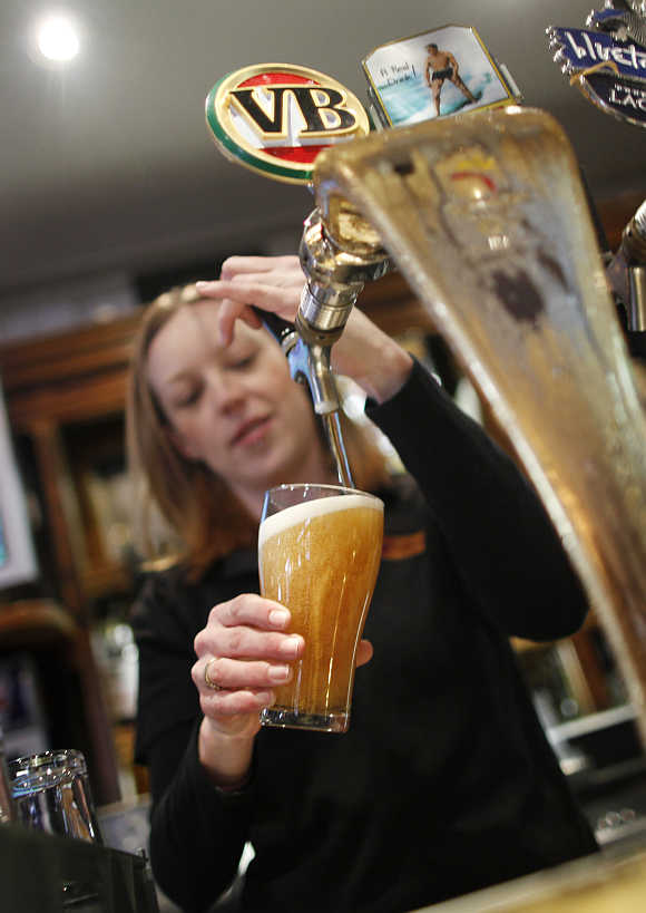 A barmaid pours a glass with beer at the Occidental Hotel in central Sydney.