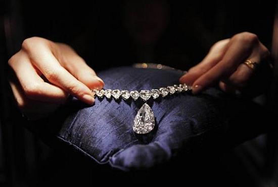 A Christie's employee places a necklace featuring the Evening Star, a 39 carat, D colour Golconda diamond, into a display case in New York.