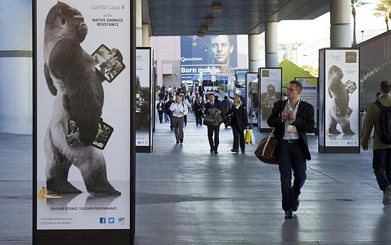 A man walks by an advertisement for Corning Gorilla Glass 3 outside the Las Vegas Convention Center.