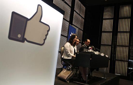 Facebook executives attend a news conference.