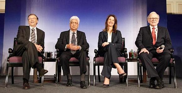 Bill Gates (L) his wife Melinda Gates, Azim Premji (2nd L) and billionaire Warren Buffett (R) attend a news conference.