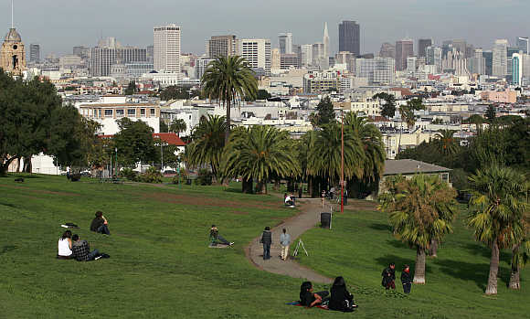 Green space of Dolores Park is shown with the skyline of San Francisco, California.