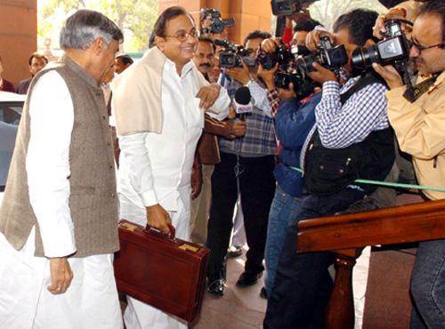 Finance Minister Palaniappan Chidambaram holds the economic survey 2012-13 report.