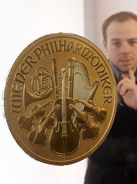 A man looks at Europe's largest gold coin in a shop in Vienna.
