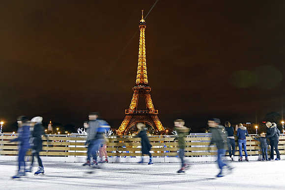 People skate on an artivicial ice rink across from the Eiffel Tower in Paris.