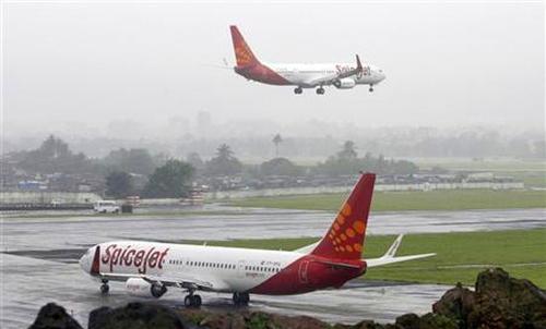 SpiceJet aircrafts prepare for landing and take-off at the airport in Mumbai.