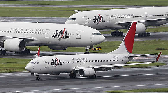 JAL aircraft are seen on the tarmac at Haneda airport in Tokyo.