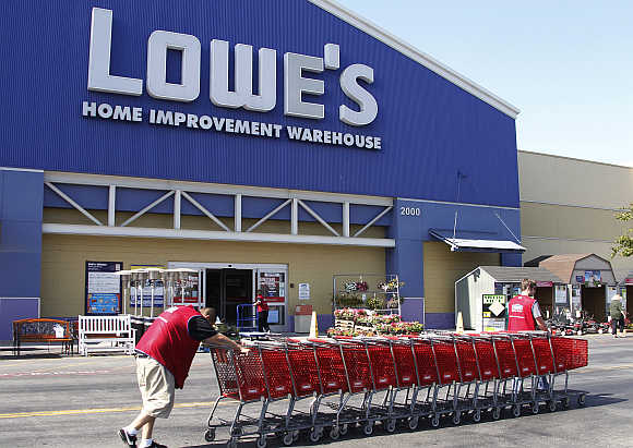 Lowe's workers collect shopping carts at the Lowe's Home Improvement Warehouse in Burbank, California, United States.