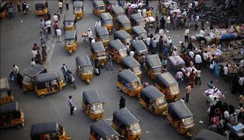 Auto rickshaws sit in a traffic jam near a market at the Charminar, Hyderabad.