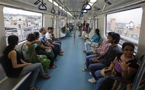 Commuters ride inside a carriage of a Namma Metro train in Bangalore.