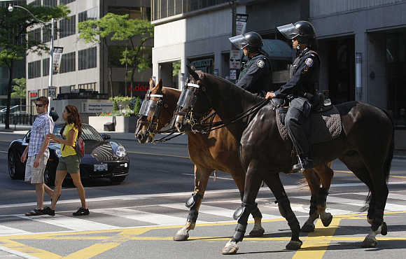 Mounted police patrol the financial district of Toronto.