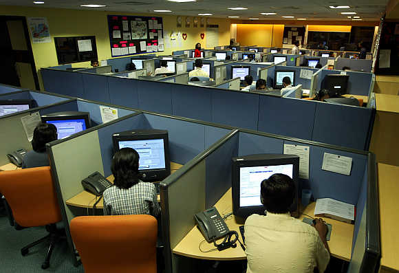 Employees at a call centre provide service support to international customers, in Bangalore.