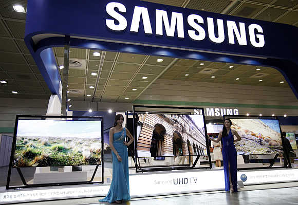 Models pose with Samsung's Ultra HD LCD televisions in Seoul, South Korea.