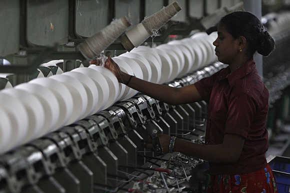 A worker tends to yarn-spinning equipment at a factory in Coimbatore.