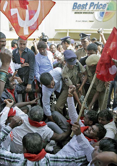 Police detain supporters of Communist Party of India protesting against foreign direct investment in retail, in front of the Bharti Walmart Best Price Modern wholesale store in Hyderabad.