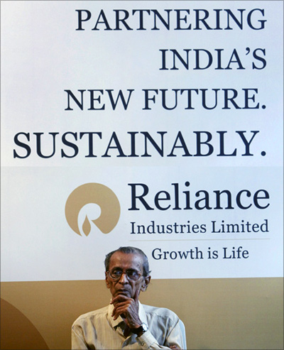 Reliance Industries shareholder sits outside the venue of the company's annual general meeting in Mumbai.