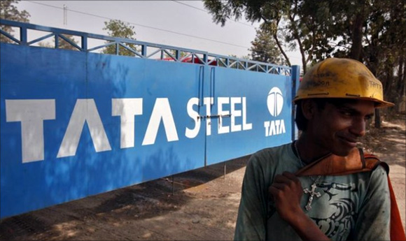 A labourer stands outside a Tata Steel stockyard in Chandigarh. 