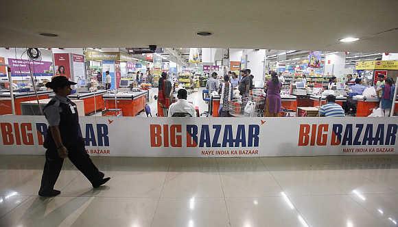 A security personnel walks past the Big Bazaar retail store in Mumbai.