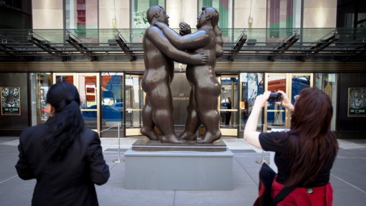 Fernando Botero's 'Dancers' is photographed by a passer-by as it sits in front of Christie's Auction House in New York.