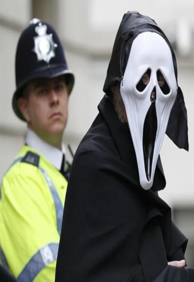 A demonstrator protesting against the upcoming G8 summit, being held near Enniskillen, Northern Ireland, wears a mask outside BAE systems headquarters in central London.