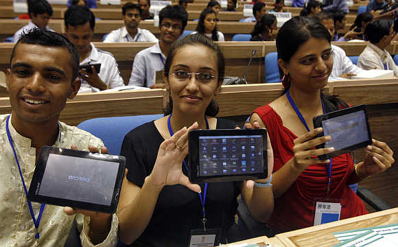 Students display Aakash tablet in New Delhi.
