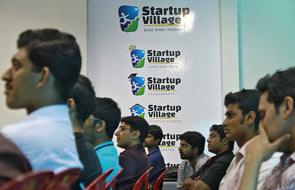 Entrepreneurs, employees and students listen to a speech during a Start-up  event at the Start-up Village in Kinfra High Tech Park in Kochi.