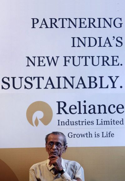 A Reliance Industries shareholder sits outside the venue of the company's annual general meeting.