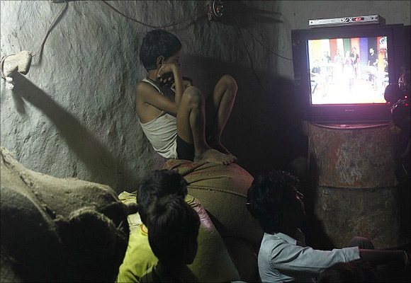 Children watch television in the Meerwada village in central India.
