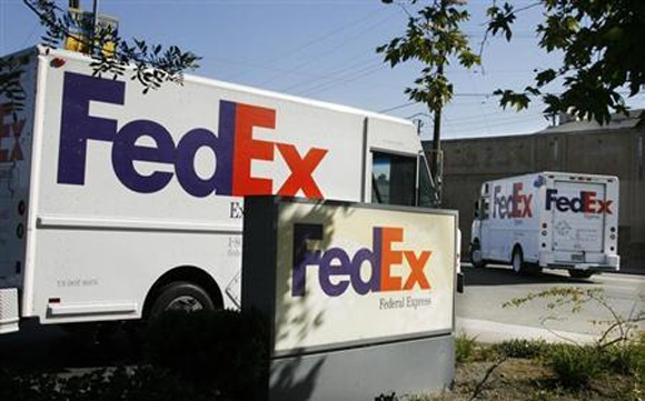 Federal Express trucks head out for deliveries from a FedEx station in Los Angeles, California.