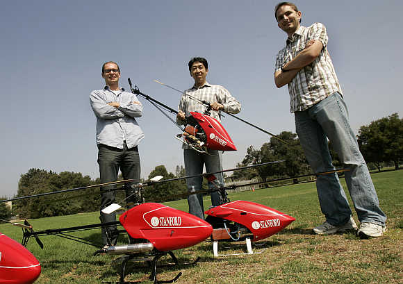 Stanford University doctoral students Peter Abbeel, left, and Adam Coates, right, are joined by computer science professor Andrew Ng prior to an air-show of robotic helicopters on the Stanford campus in Palo Alto, California.