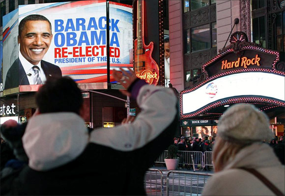 People celebrate in Times Square, New York, after Barack Obama wins the 2012 US presidential election.
