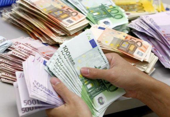 A bank employee counts Euro notes at Kasikornbank in Bangkok.