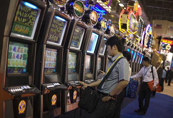 People play slot machines in Macau.