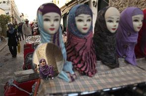 Headscarves are displayed on plastic models at a market stall. Photograph: Mohammed Salem/Reuters