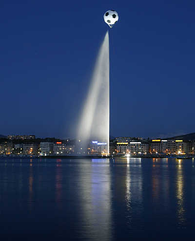 A giant helium-inflated soccer ball flies over the jet d'eau, or water fountain, at the Lac Leman in Geneva, Switzerland.