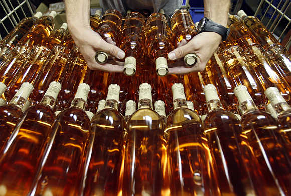 A worker prepares bottles of rose wine at the Domaine Saint Andre de Figuiere at La Londe Les Maures in Provence, France.