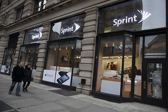 People walk past a Sprint store in New York City.