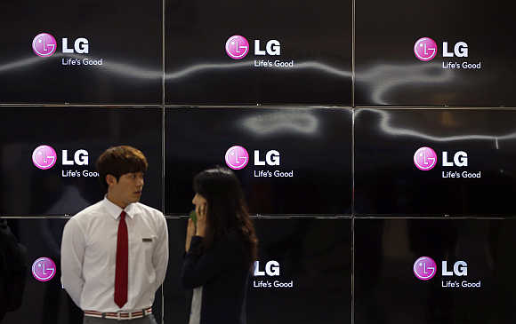 Visitors stand in front of LG Electronics' TV sets at the Coex convention centre in Seoul, South Korea.