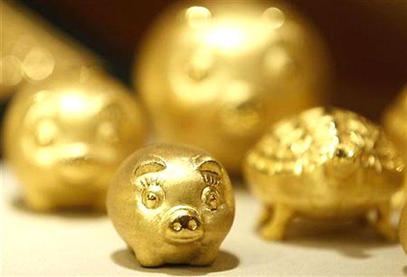 Gold pigs are displayed for customers at a jewellery shop at the Shinsegae department store in Seoul.