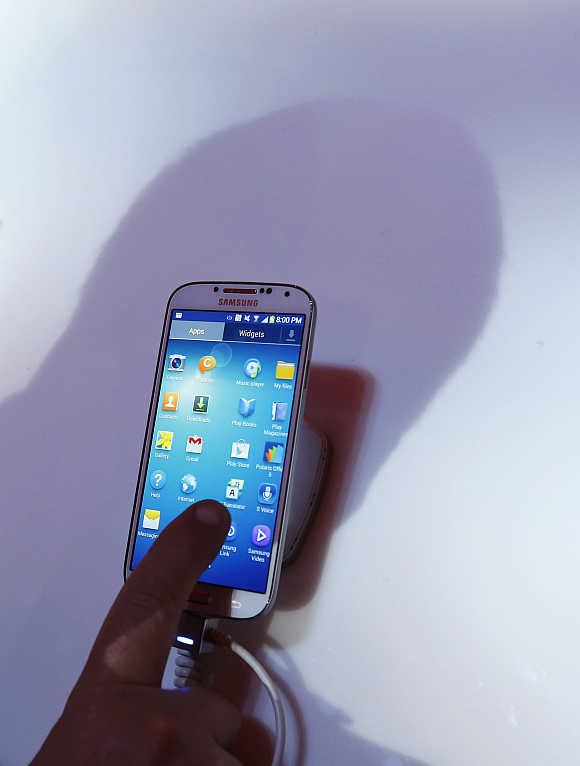 An event goer uses Samsung Galaxy S4 smartphone at the Radio City Music Hall in New York.