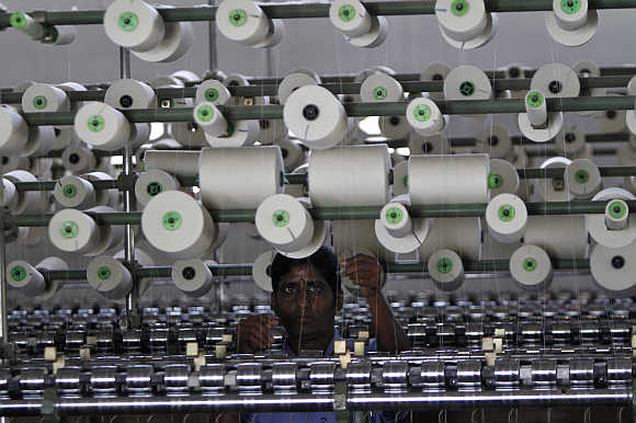 A worker tends to yarn-spinning equipment at a factory in Coimbatore.