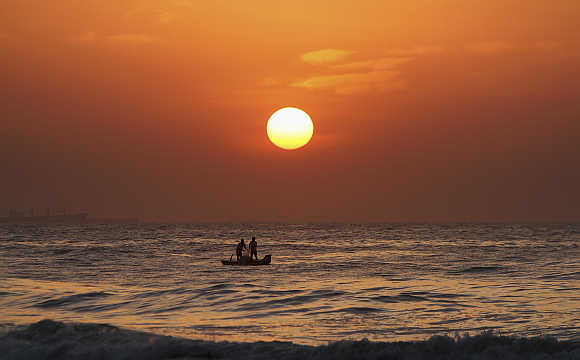 Fishermen pull their fishing net from the waters of Bay of Bengal during sunrise in Chennai.