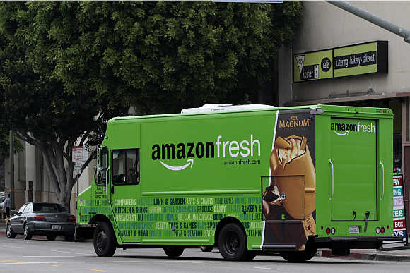 An Amazon Fresh delivery van moves down Pico Bloulevard in Los Angeles, California.