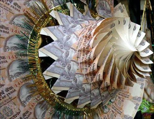 Rupee notes are stapled to form a garland at a market in Srinagar.