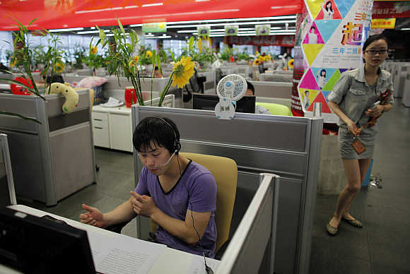 An employee talks on the phone at the call centre of Alibaba (China) Technology at its headquarters on the outskirts of Hangzhou, Zhejiang province.