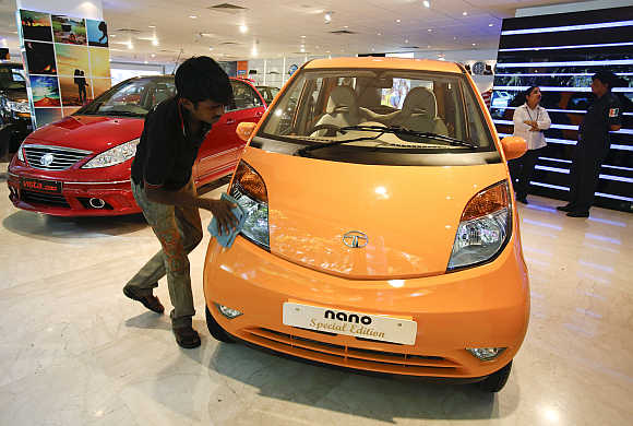 A showroom attendant cleans a Tata Nano at their flagship outlet in Mumbai.