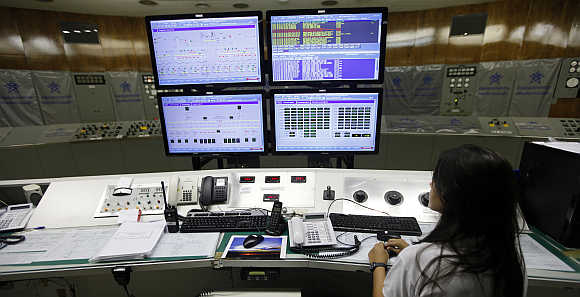 A technician works in the control room inside Furnas hydroelectric dam in the city of Sao Jose da Barra in the state of Minas Gerais in central Brazil.